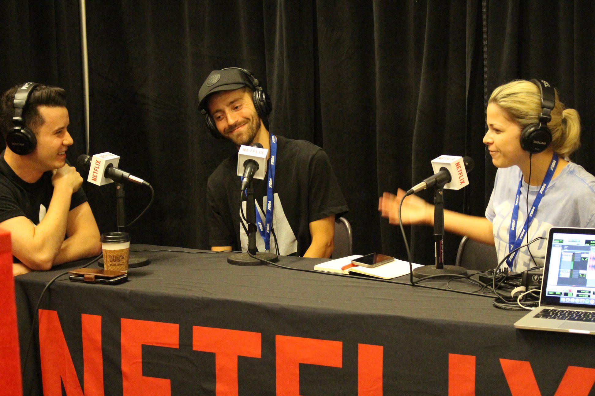 People in the netflix podcast studio talking and laughing